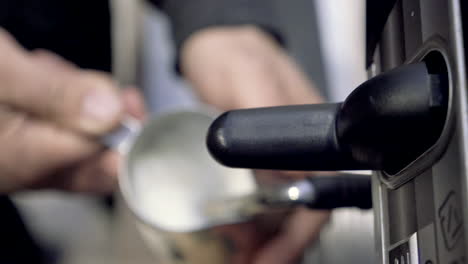 barista steaming milk with espresso machine for latte or cappuccino