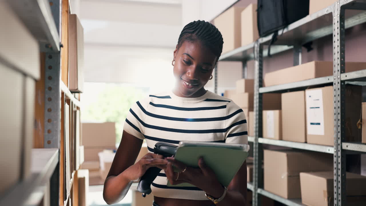 Young Woman Scanning Packages and Using Tablet in Warehouse