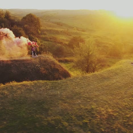 couple walk with color smoke bombs