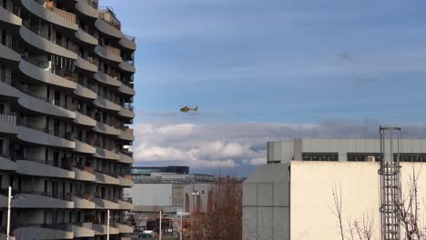 helicopter starts in the distance, takes off and disappears behind an apartment complex