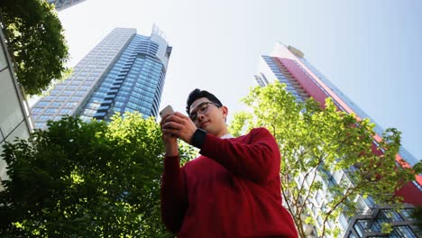 Man-using-mobile-phone-on-street-4k