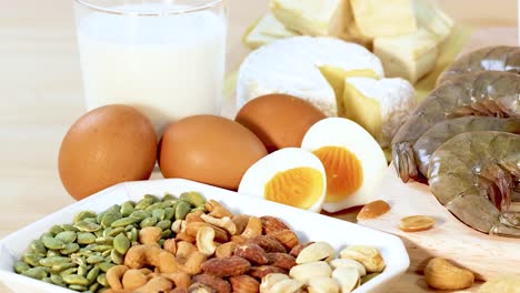 a variety of protein-rich foods including eggs, nuts, dairy, and meats are artfully arranged in a well-lit setting