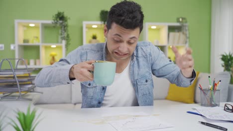 clumsy man spilling coffee on his work desk is damaging his document. awkwardness.