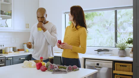 multiracial couple preparing fresh vegetables in kitchen, enjoying healthy lifestyle, at home