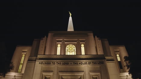 lds church mormon temple at night in gilbert, arizona with sign that says "holiness to the lord - the house of the lord