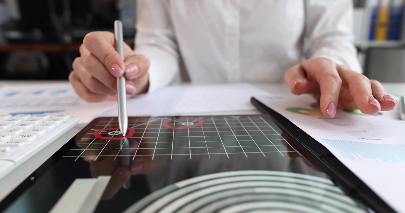 Woman business specialist analyzes stock market data on tablet