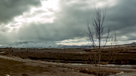 time lapse of a winter mountain scene and urban area - sliding left