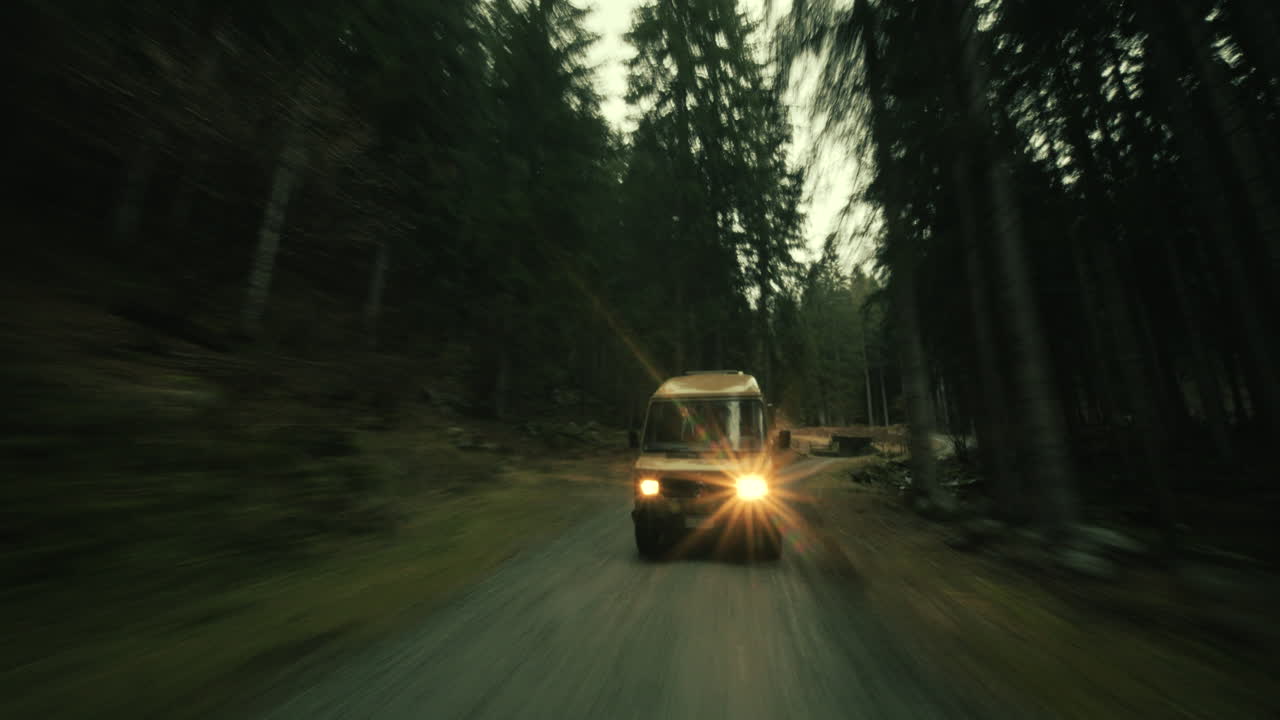 Van Driving Through a Forest