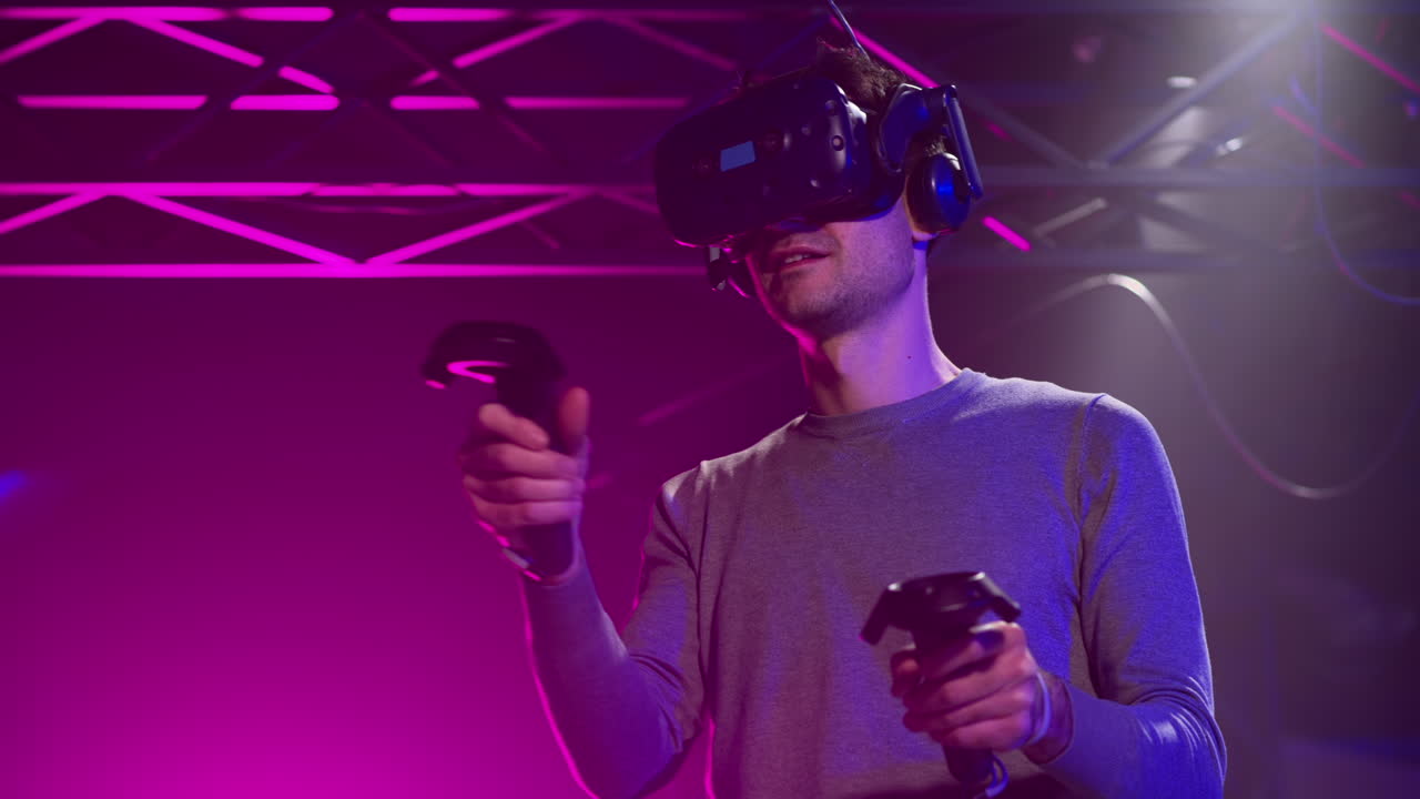Man playing with a Virtual Reality headset in a studio