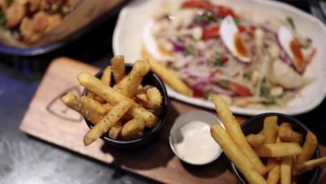 enjoying fries and salad with dipping sauce