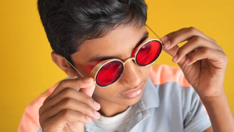 boy with red round sunglasses