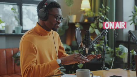 male and female radio hosts broadcasting in audio studio