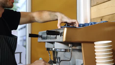 Male-waiter-cleaning-coffeemaker-machine-4k