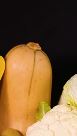 assorted vegetables displayed against a dark backdrop