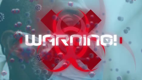 Animation-of-warning-text-and-virus-cells-over-man-wearing-face-mask