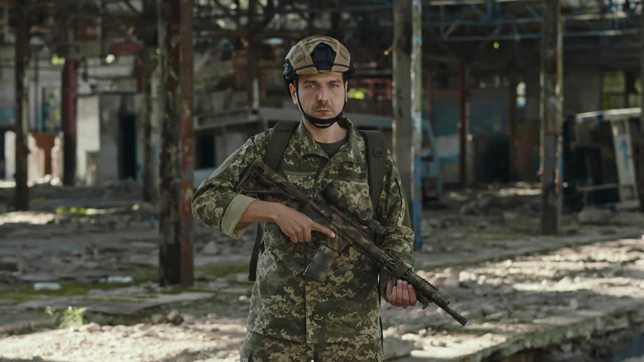 Soldier in Camouflage Uniform at a Destroyed Factory