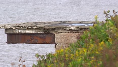 A-rusty-old-abandoned-structure-on-a-cliff-nearby-the-seaside