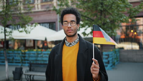 man holding german flag in city