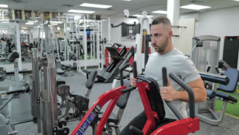 muscular man actively training in the modern gym