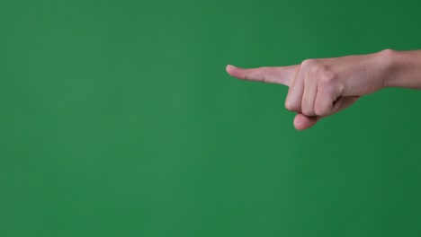 hand pointing finger over green background