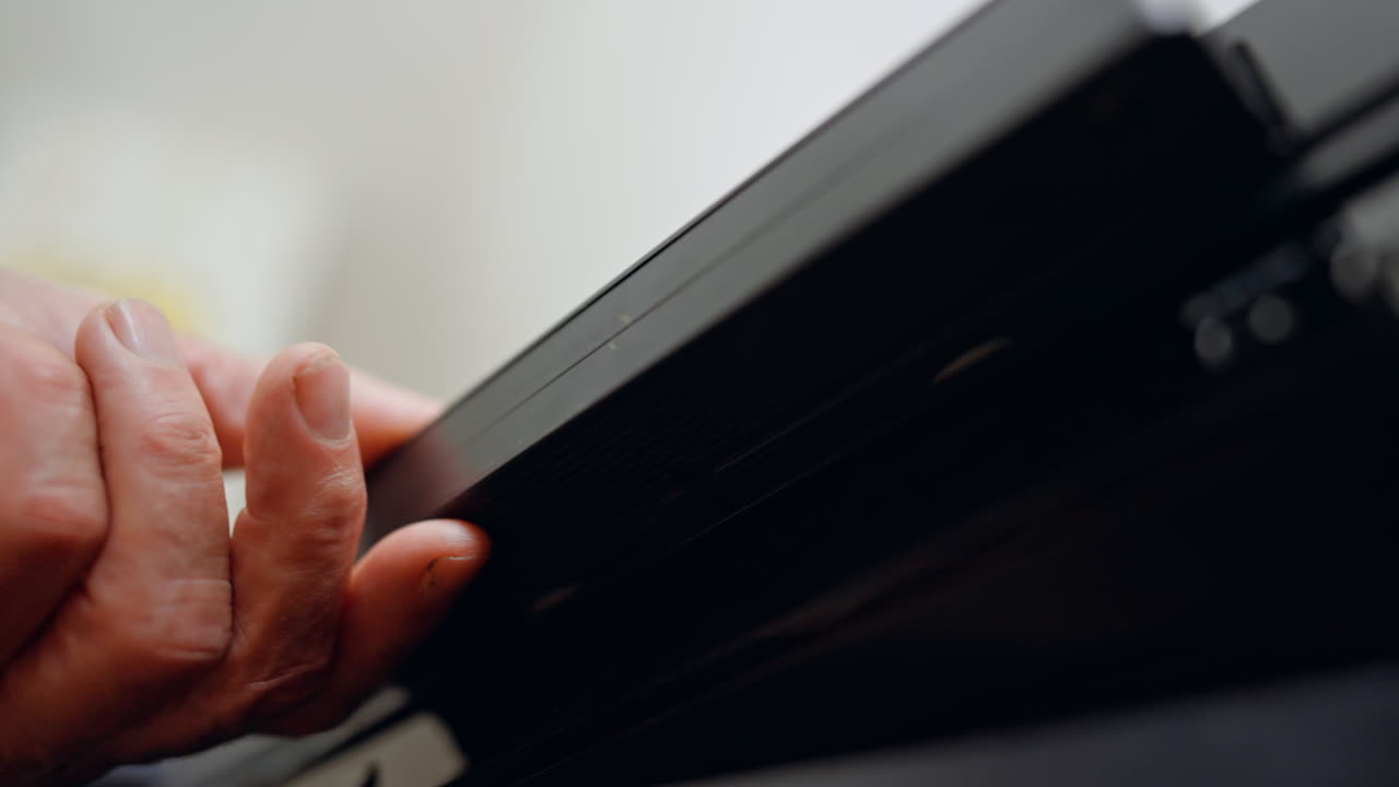 Video Home System front panel. Low angle close up. Tape shoots out and hand takes it away