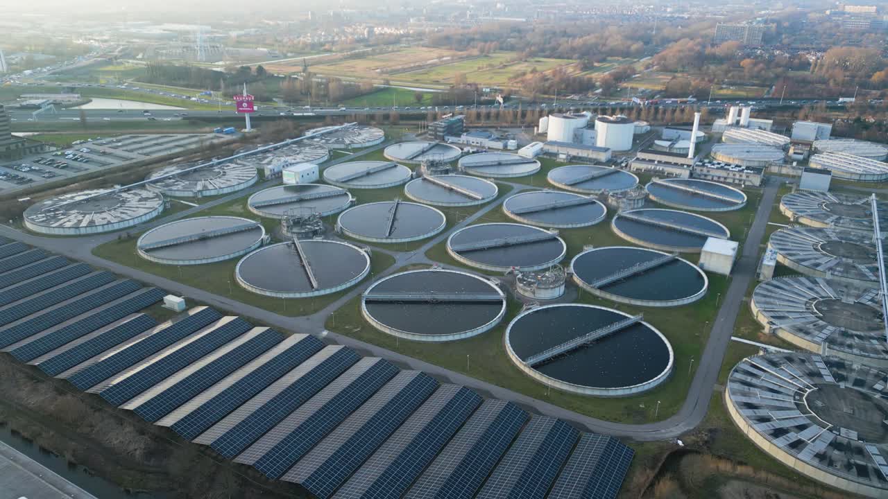 Drone shot of multiple circular clarifier tanks at a large wastewater treatment facility
