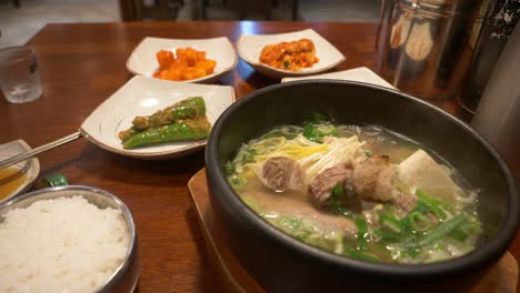 steaming pork rib noodle soup and sides