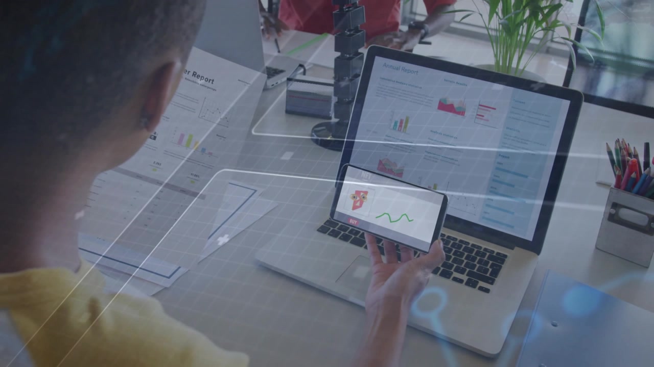 Coworkers reviewing finance charts in office workspace, interacting with digital graph overlays