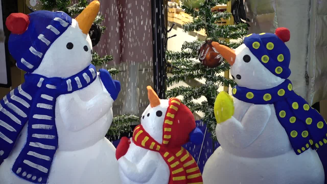 Snowmen in an inverted umbrella
