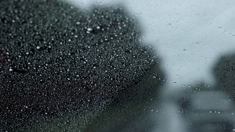 raindrops on window during urban car ride