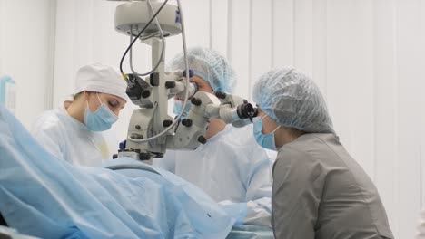 surgery team making strabismus surgery using modern technologies, latest devices, microscope in modern clinic