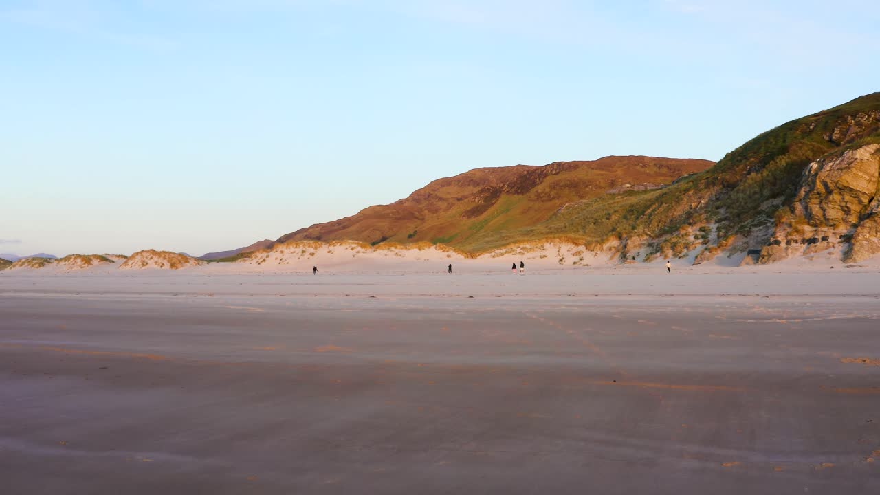 Maghera Beach Sandscape With People Walking During a Soft Sunset