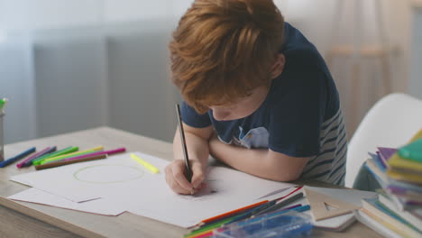 boy drawing at desk