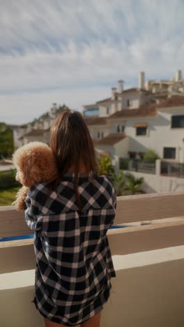 girl with dog on balcony