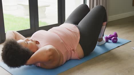 video of plus size african american woman exercising at home