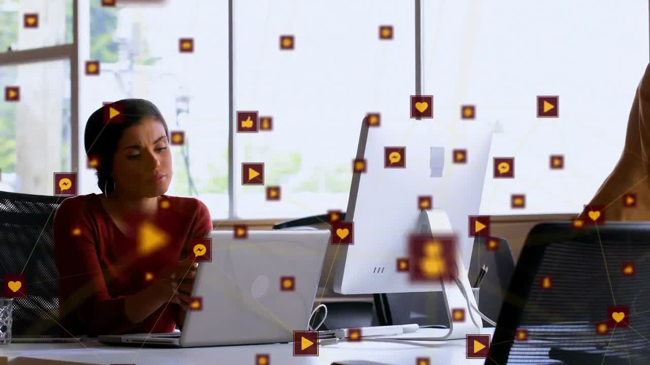 Animation of network of digital icons over biracial woman using laptop at office