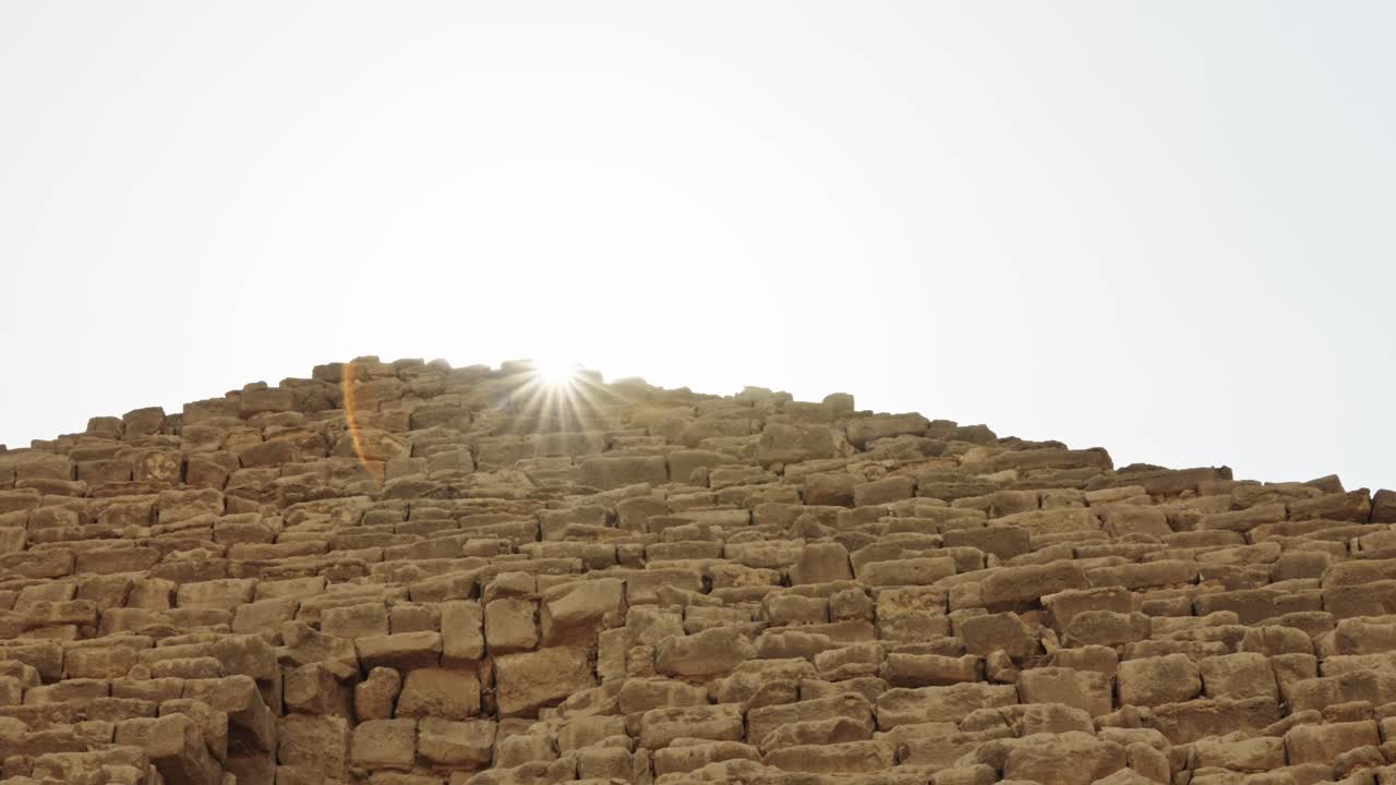 Pyramid of Menkaure emphasizing glow of the sun on the ancient stones. Birds in flight, highlighting the contrast between the eternal stone monument and the natural, passing world