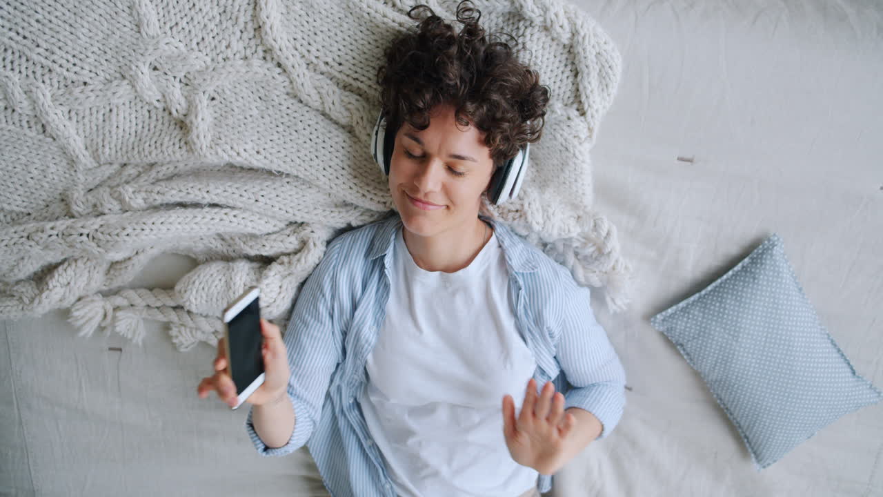 Woman Relaxing with Headphones and Smartphone