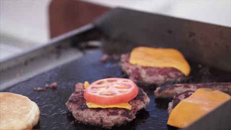 preparing burgers on a griddle