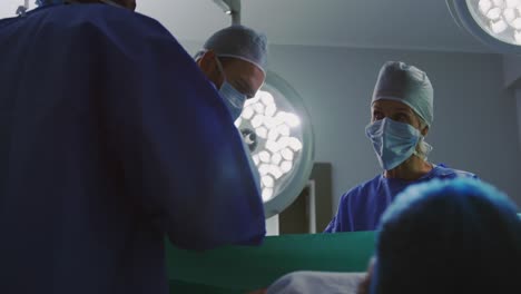 Low-angle-view-of-surgeons-operating--pregnant-woman-in-operation-theater-4k
