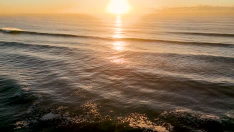 sunrise reflecting on calm ocean waves