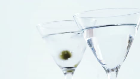 Olives-falling-in-two-cocktail-glasses