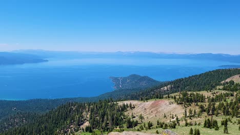 agua azul cristalina y brillante del lago tahoe rodeada de bosques de pinos y vistas a las montañas durante una caminata en california