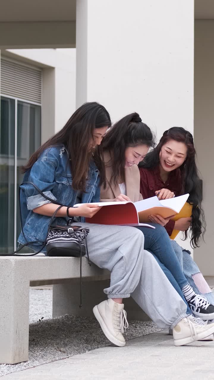 three asian girl students talking at break time sitting on campus