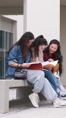 three asian girl students talking at break time sitting on campus