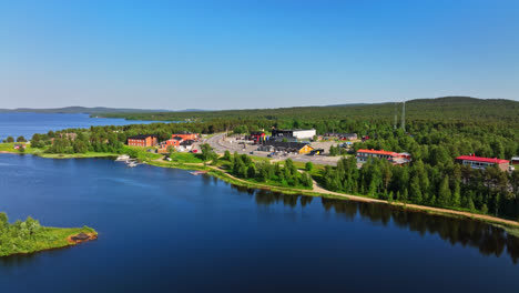 Establishing-drone-shot-of-the-Inari-town,-sunny,-summer-day-in-Lapland,-Finland