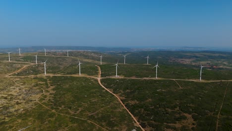 high aerial establishing shot of rows of windmills at a french windmill farm