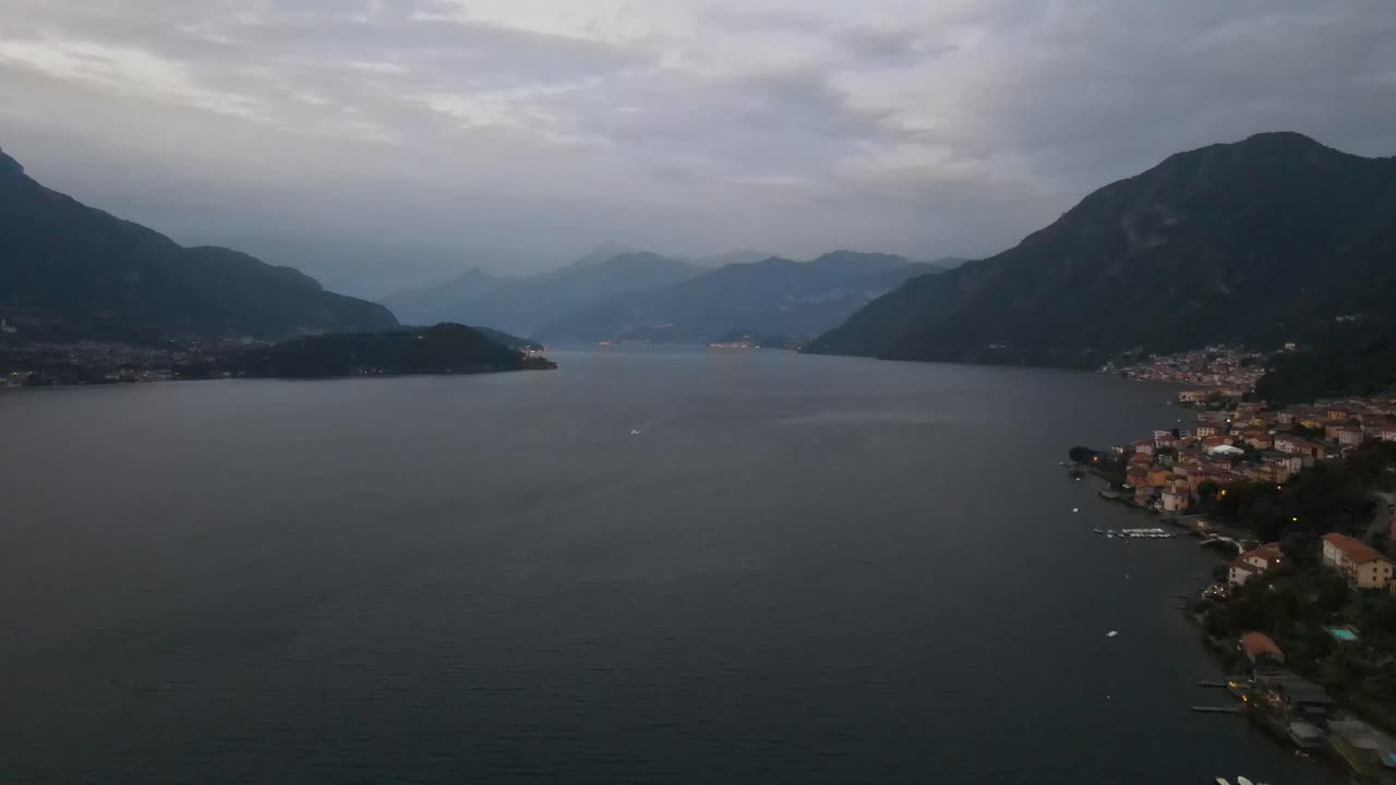 beautiful areal panorama of the com lake in the middle of Italy in the alps while sunset.