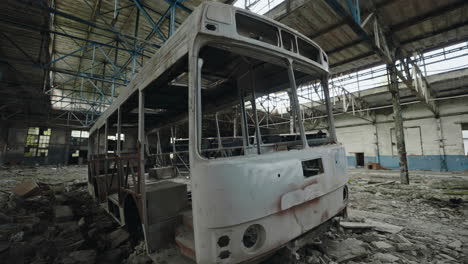 abandoned bus in a derelict factory