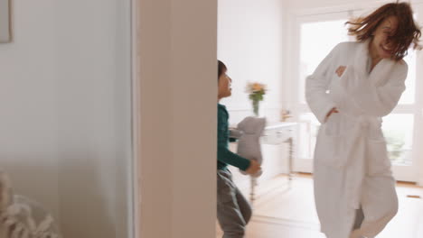 happy-little-asian-boy-playing-catch-with-mother-running-through-house-enjoying-fun-weekend-morning-with-child-4k-footage